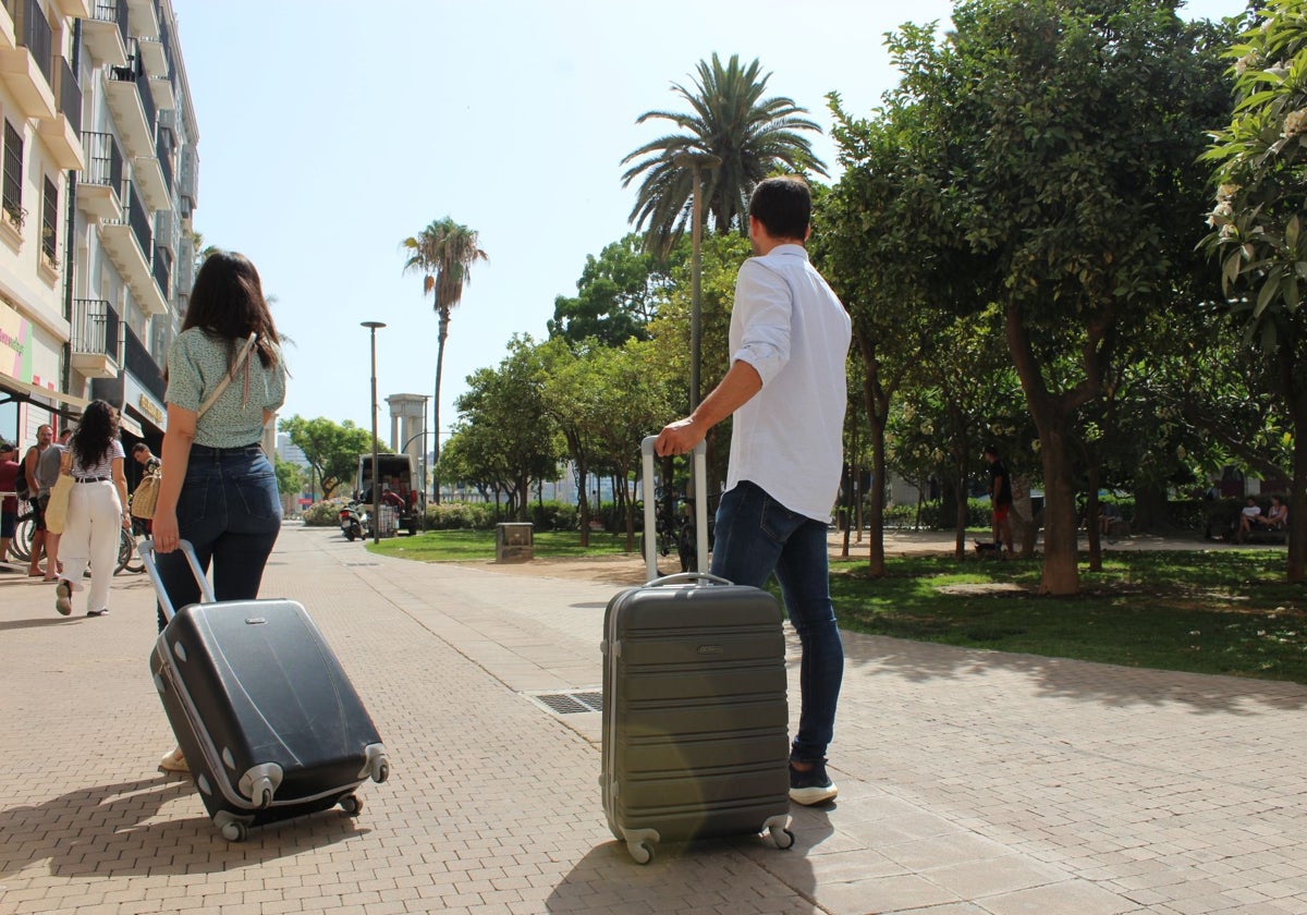 Turistas se dirigen a un céntrico hotel de la capital de la Costa del Sol.