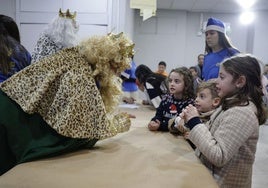 Los trillizos Mila, Triana y Manuel hablando con los Reyes Magos este viernes en la sede de Anpavi de Málaga, en La Corta.