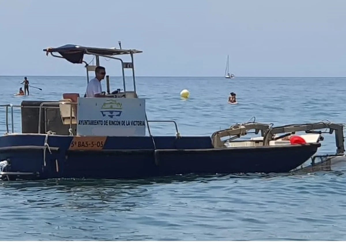 Una embarcación de limpieza de aguas superficiales en Rincón de la Victoria.