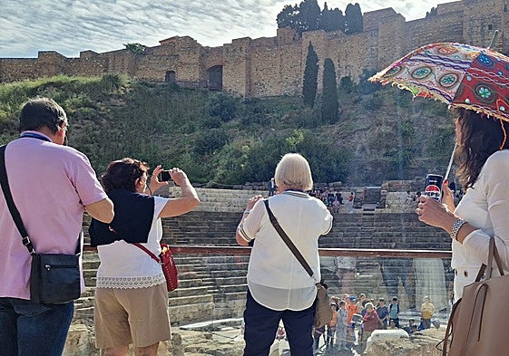 Turistas inmortalizan la vista de la Alcazaba y el Teatro Romano.