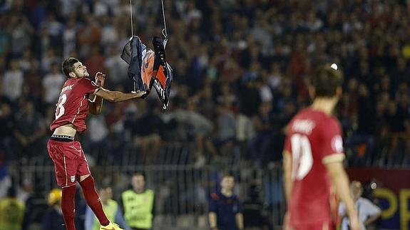 Un jugador de Serbia retira la bandera del dron. 