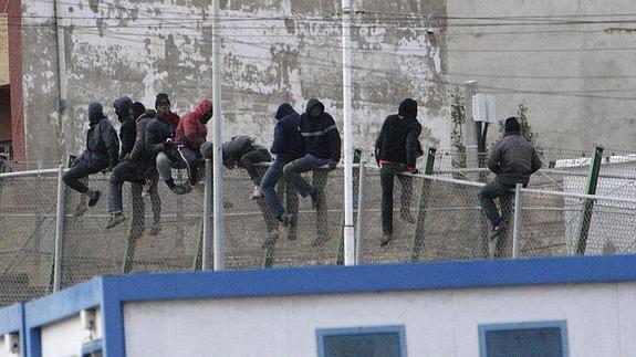 Inmigrantes encaramados a la valla de Melilla. 