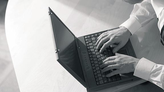 Un hombre utiliza un ordenador portátil.