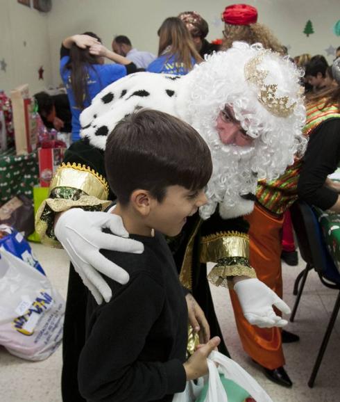 Un niño recibe su regalo de Reyes Magos. 