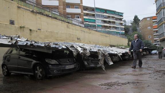 El techo metálico de un aparcamiento de la calle Miguel Induráin cayó sobre una docena de vehículos.