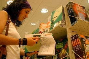 Una joven busca libros en un establecimiento. :: sur