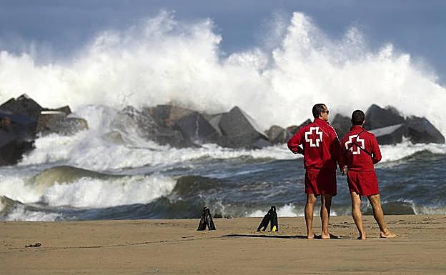 Dos miembros de la Cruz Roja vigilan una playa. 
