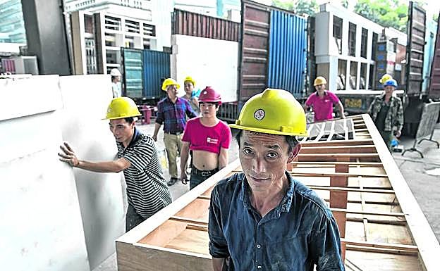 Imagen principal - Del campo . Emigrantes rurales de todos los rincones de China acuden a las ciudades sabiendo que allí necesitan mano de obra pra levantar los estands.