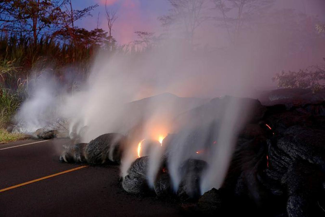 Los gases volcánicos se elevan desde el flujo de lava de Kilauea que cruzó Pohoiki Road cerca de la carretera 132, cerca de Pahoa, Hawaii, EE.UU. 