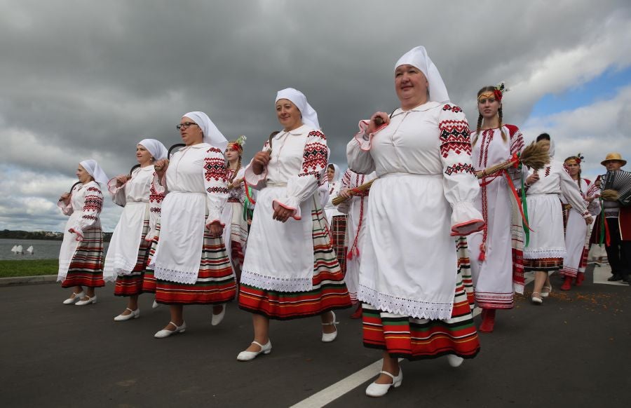 Los artistas bielorrusos cantan canciones tradicionales y bailan durante el desfile 'A path to a bread' o 'Un camino hacia el pan'. El desfile forma parte del festival regional 'Dazhynki' que marca el final de la temporada de cosecha en la ciudad de Myadzel, Bielorrusia.