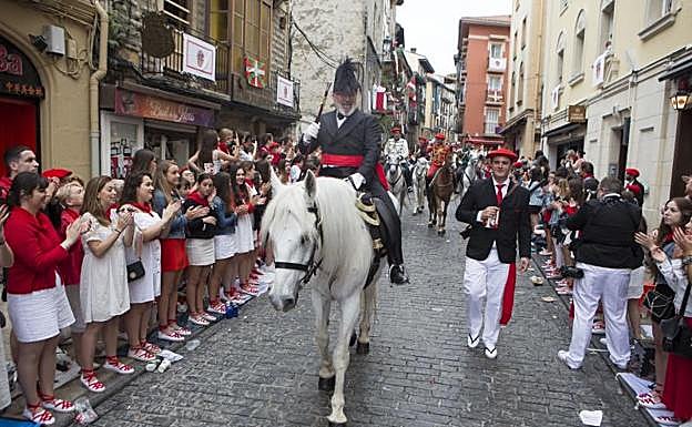 El público aplaude al general, Paco Carrillo, mientras desciende la calle Mayor acompañado por el cornetín, Jon Agudo. 