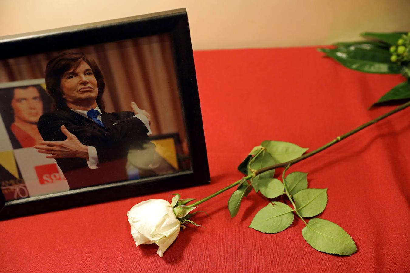 Una rosa blanca descansa frente a una imagen del cantante Camilo Sesto en la capilla ardiente.