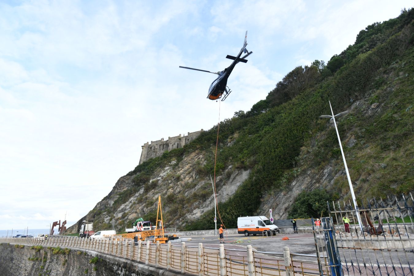 Un helicóptero ha sido el encargado de trasladar, por piezas, la grúa para la obra del Faro.