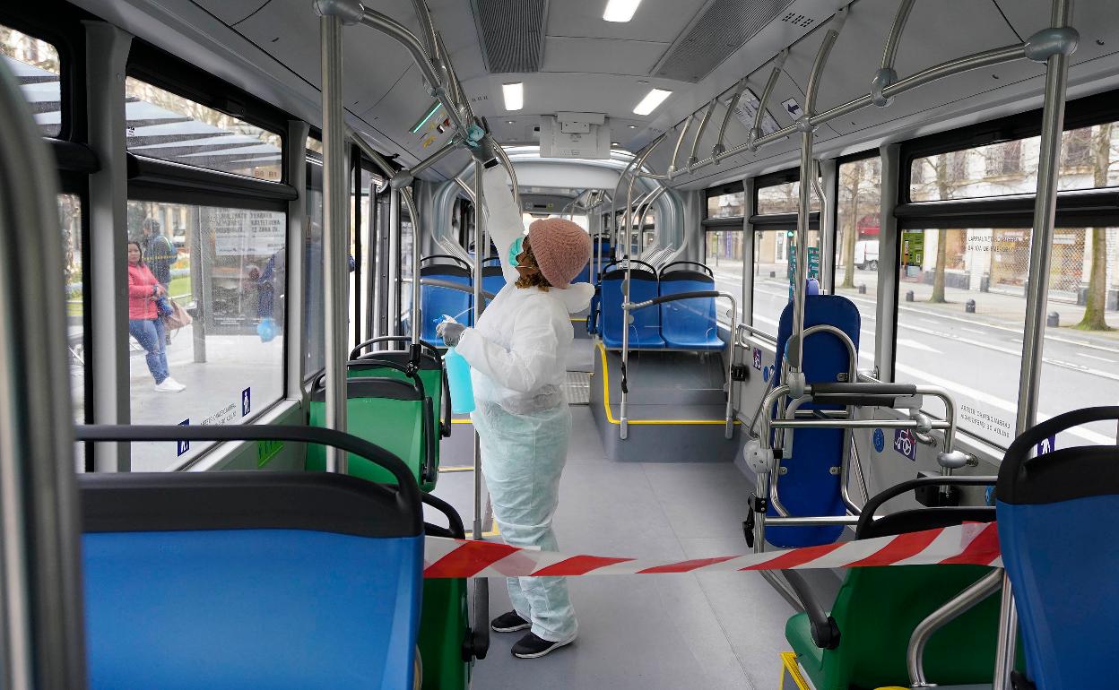 Una trabajadora limpia un autobús municipal de Donostia. 