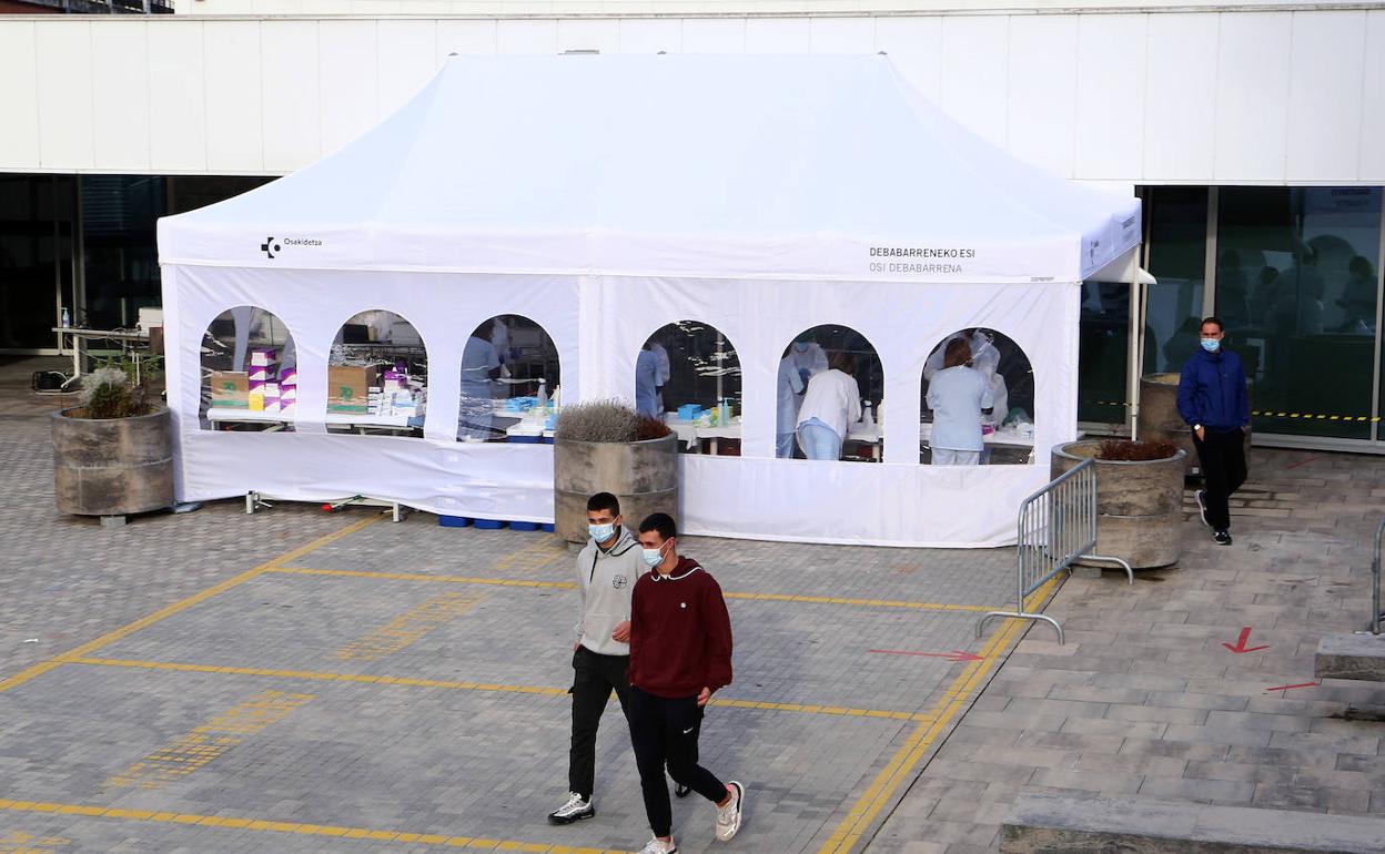 Dos jóvenes tras realizarse la PCR en la carpa instalada en el aparcamiento del Hospital de Eibar.