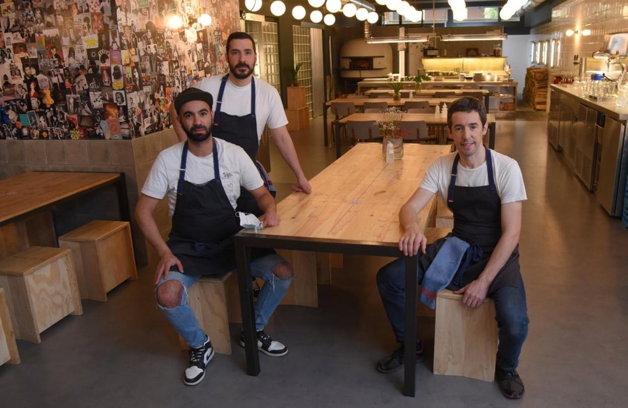 Arriba, el equipo de Humo Negro. A la derecha, dos de las deliciosas pizzas que cocinan en su horno. 