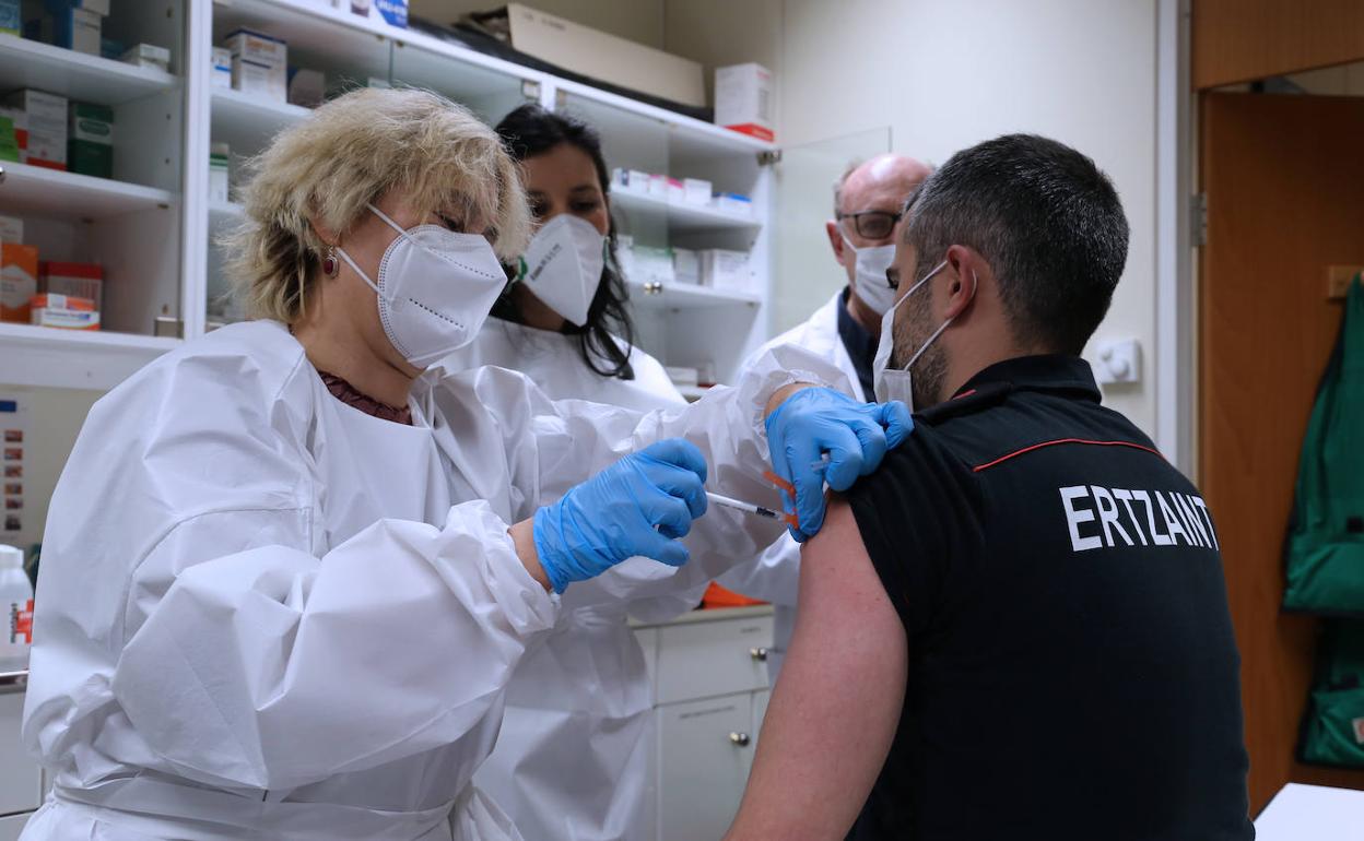 Un agente de la Ertzaintza recibe la vacuna de AstraZeneca, ayer en el primer día de vacunación en este colectivo. 