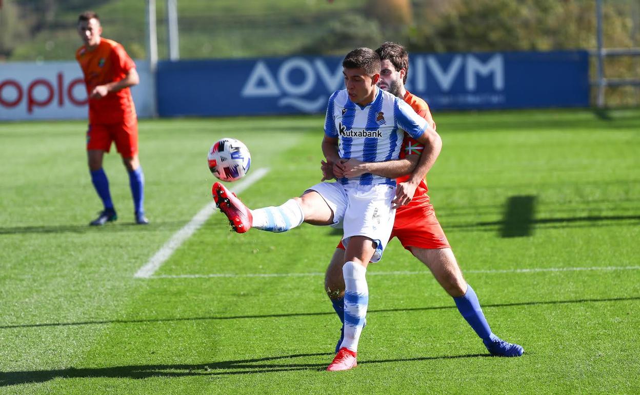 Jon Karribaburu se dispone a controlar el balón ante la presión del capitán del Tolosa.