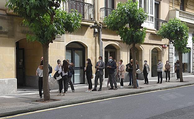 Jóvenes y sus familiares hacen cola en el cuarto de socorro de San Sebastián donde se está llevando el cribado.