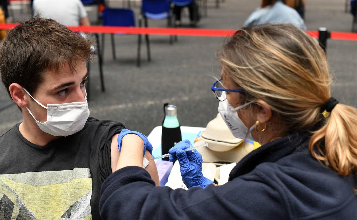 Un joven recibe la vacuna contra el coronavirus en el coso de Illunbe de San Sebastián, durante el periodo de vacunación a colectivos esenciales.