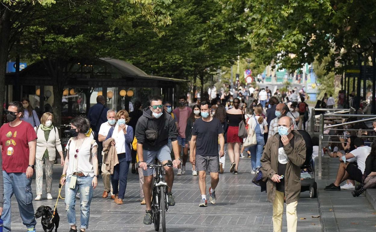 qPeatones con mascarillas. Esta imagen que fue habitual durante meses puede regresar si no se contiene el avance del coronavirus. 