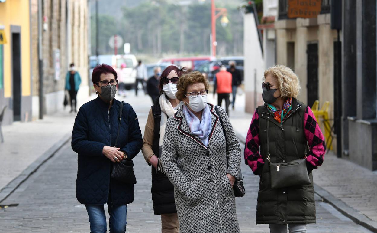 Paseantes con mascarilla por Zumaia.