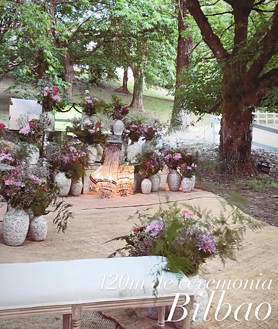 Imagen secundaria 2 - El pasillo por el que los novios han llegado al altar donde se han dado el sí quiero, un lugar repleto de velas y flores.
