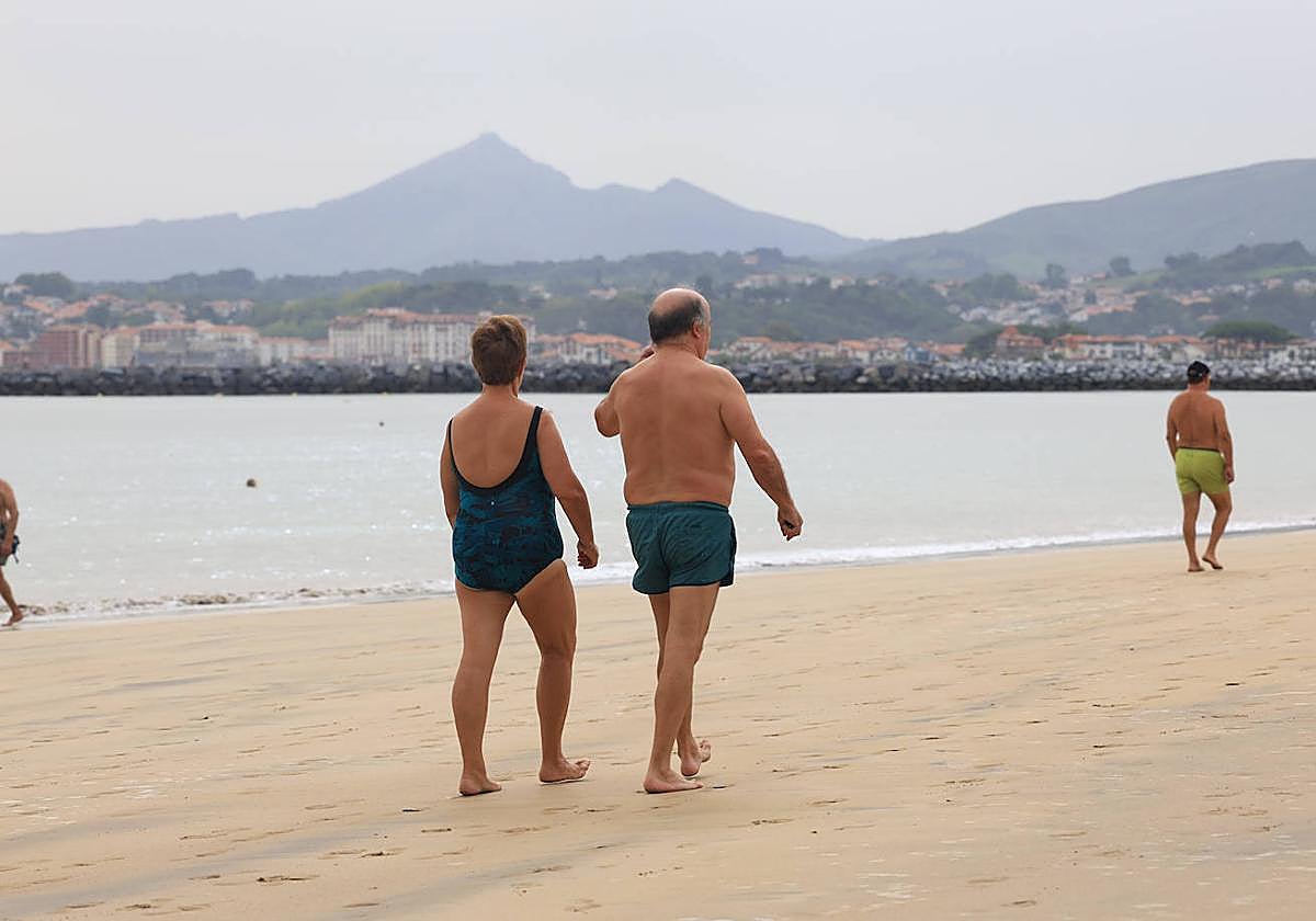 Una pareja pasea por la playa de Hondarribia este lunes.