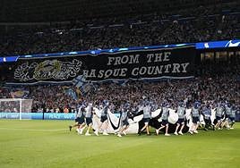 Los operario retiran la lona de la Champions poco antes de comenzar el partido.