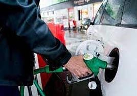 Un hombre reposta en una gasolinera.