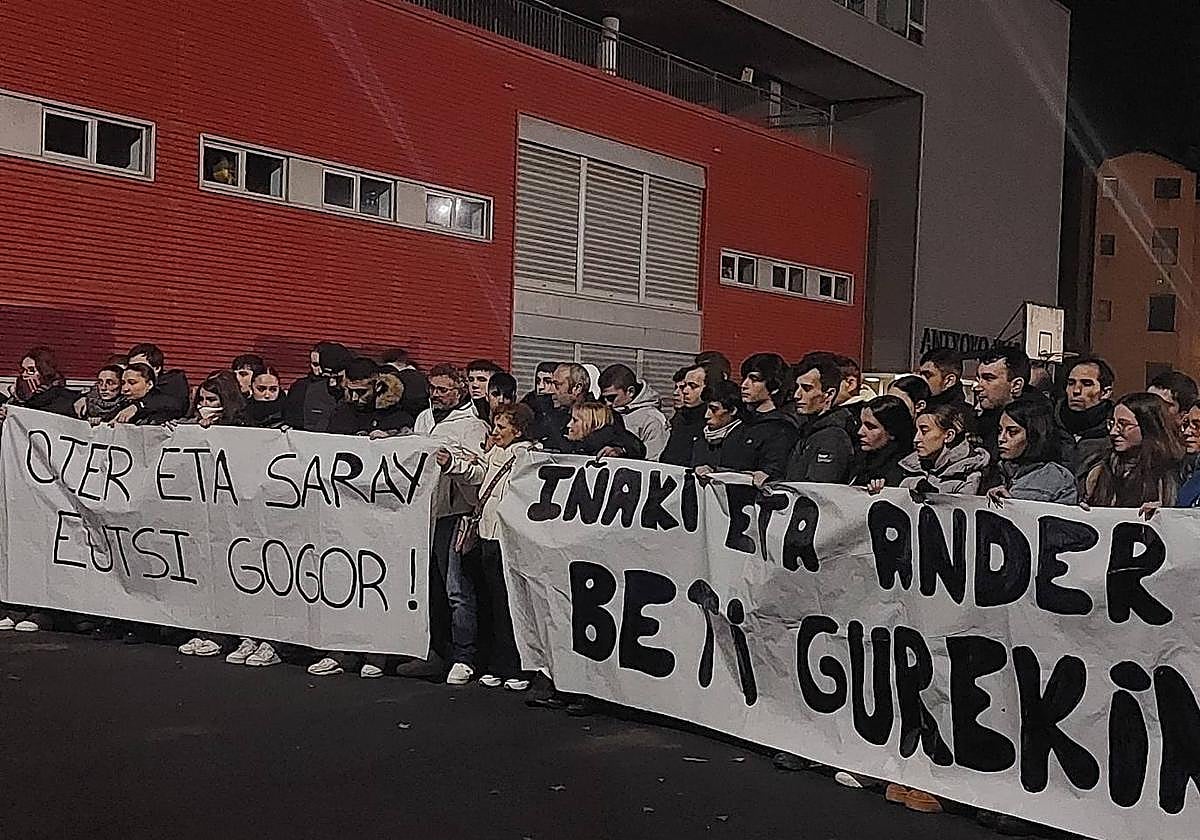 Los padres de Ander e Iñaki, en medio de las dos pancartas que se mostraron en el acto.