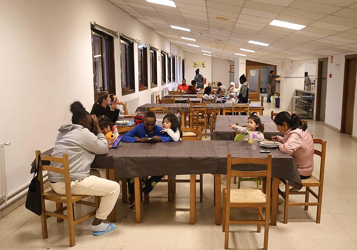 Varias personas, algunas con hijos menores, coinciden en el comedor durante la merienda.