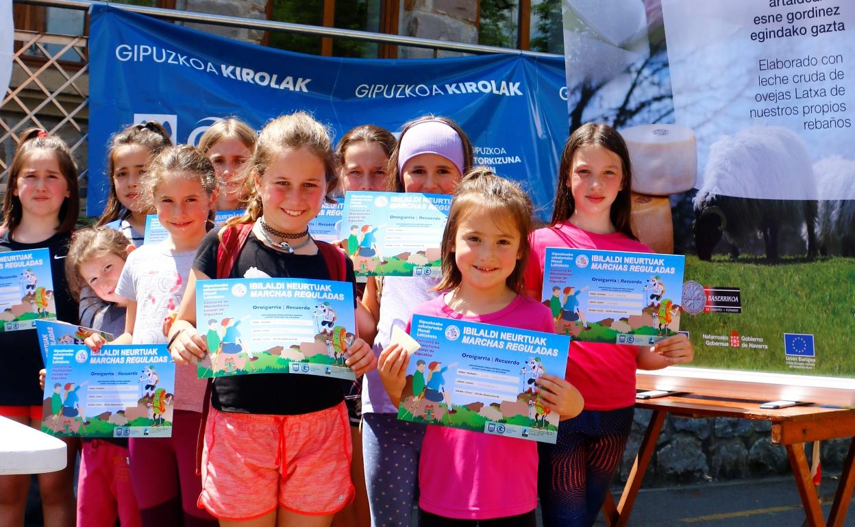 Escolares participantes en una marcha de montaña regulada con sus diplomas. 