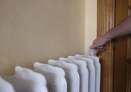 Una persona enciende el radiador en su casa.