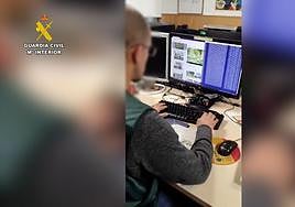Un agente de la Guardia Civil interviene uno de los ordenadores con material pedófilo.