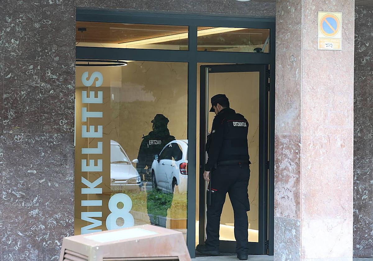 Dos ertzainas acceden al portal del bloque donde ocurrió el crimen.