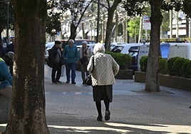 Una mujer mayor camina por la calle en Tolosa.