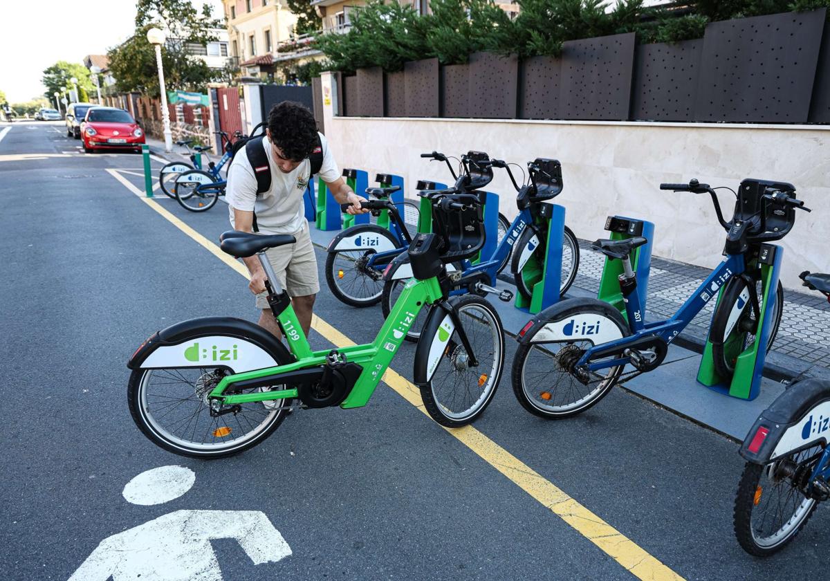 Un usuario de Dbizi selecciona una bicicleta eléctrica en la estación situada en Ondarreta.