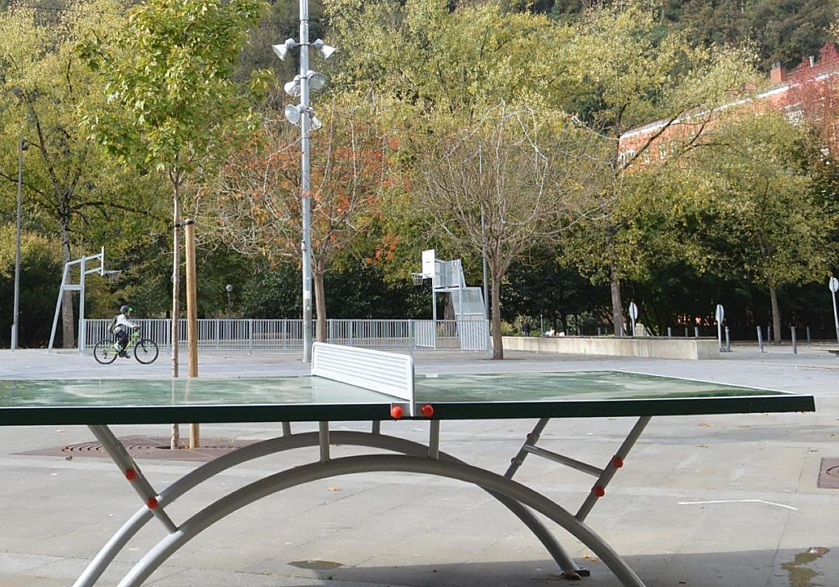 En primer término, la mesa de ping pong, y al fondo, la pista multideportiva con las canastas.