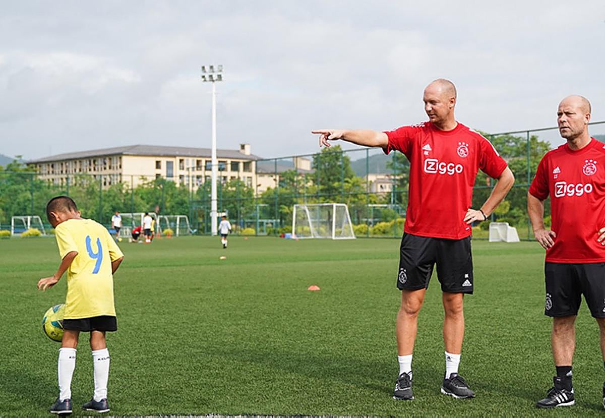 Un técnico del Ajax observa a un niño en la ciudad deportiva De Toekomst.