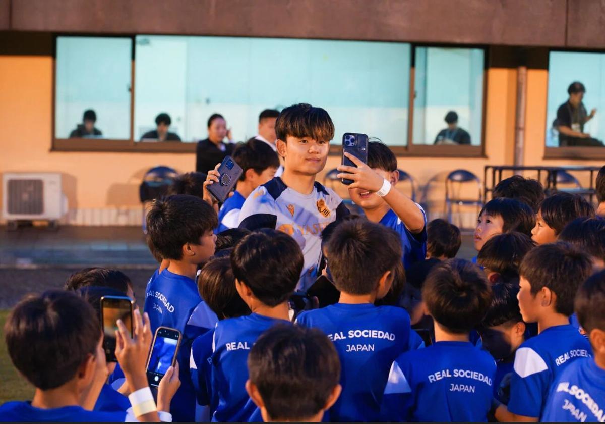 Un grupo de niños japoneses se hace selfies con Take Kubo