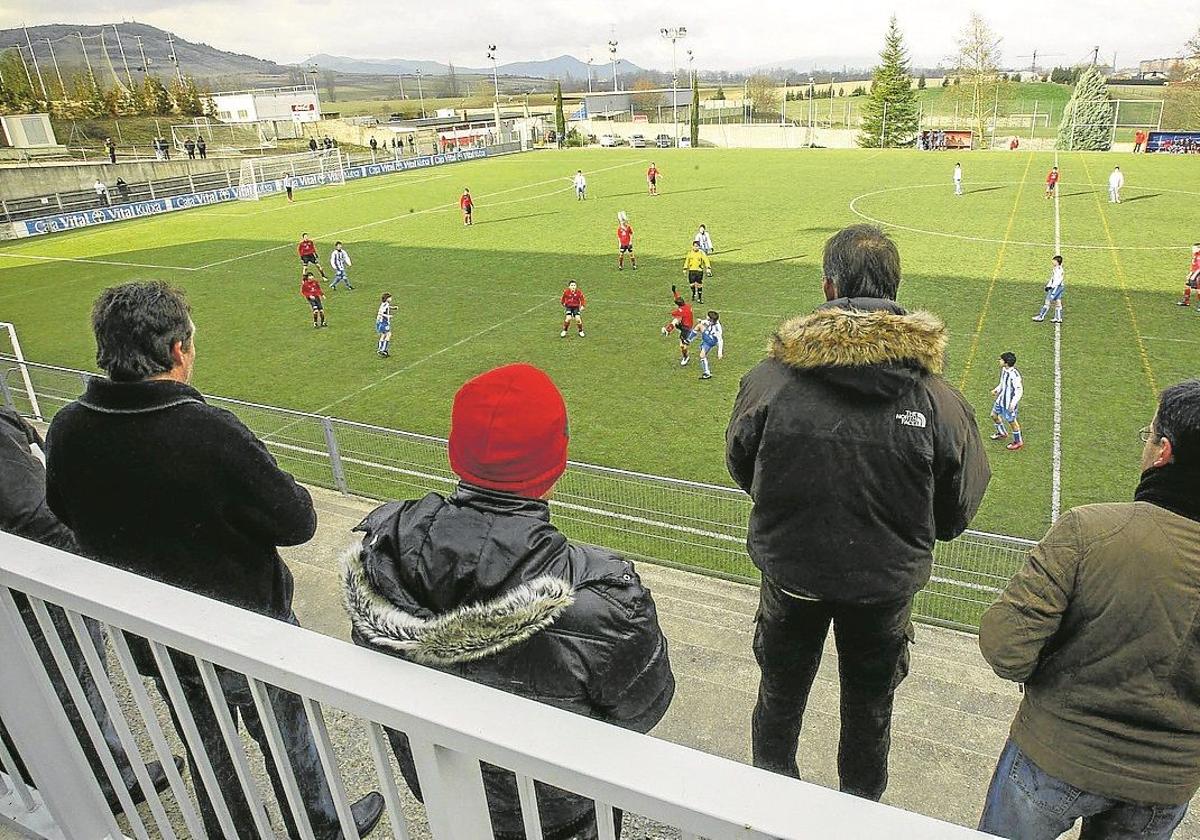 Un grupo de padres en un partido de fútbol entre menores.