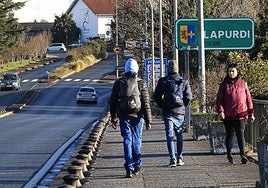 Dos migrantes cruzan el puente Santiago de Irun en dirección Hendaia.