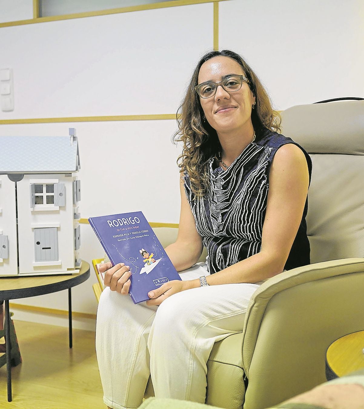 La psicóloga Daniela Corao posa con su cuento sobre el duelo migratorio 'Rodrigo se fue a otro lugar'.