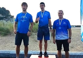 Lander Rodríguez en lo más alto del podio, escoltado por Fernández (ATSS) y Aizpurua (Zumaia), que comparten color corporativo con Pasaia Kayak.