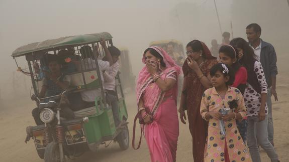 Viandantes se cubren nariz y boca en las calles de Nueva Delhi.
