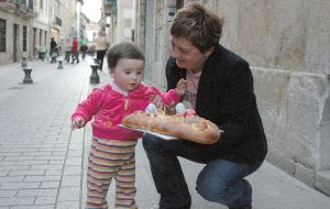 Una niña acompañada de su tía con uno de los sabrosos karapaixos, de la Panadería Egaña. [MARIAN]