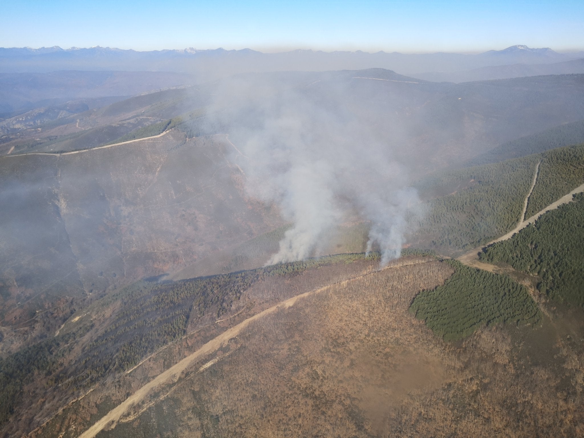 Varios brigadistas y helicópteros trabajan en la extinción de un incendio decretado este martes.
