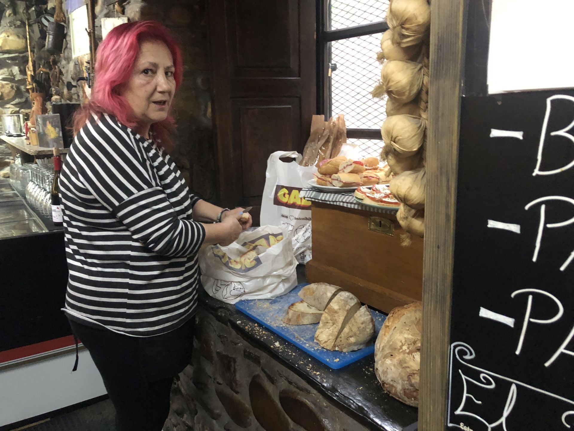 Ana Rodríguez corta el pan para las sopas de ajo.