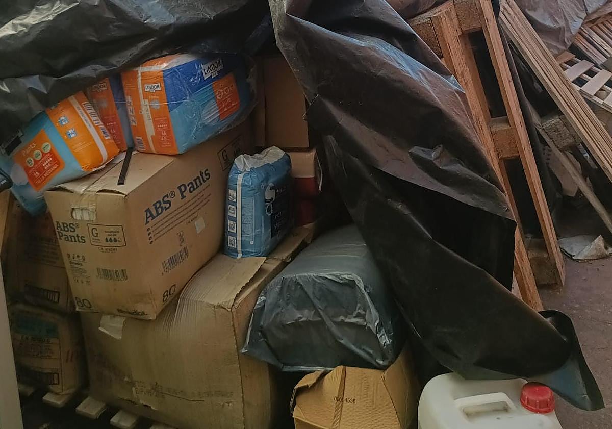 Imagen principal - Imágenes de los pañales apilados en el exterior e interior del recinto (arriba y centro) y uno de los espacios donde se albergaban ya vacío (abajo). 
